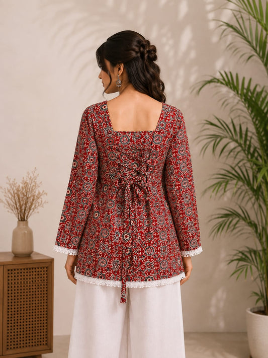 Back view of red printed kurta with tie-up detail and white palazzo