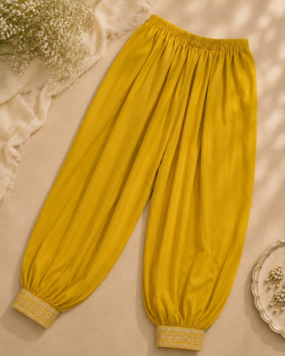 Mustard yellow gathered trousers with embroidered cuffs

