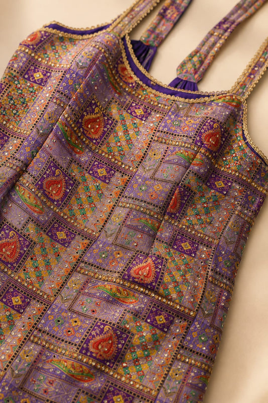 Close-up of purple printed kurta with intricate neckline and hem detailing