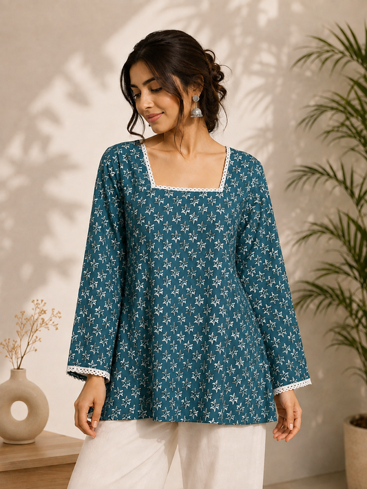 Women wearing a teal floral printed kurta with lace-up back detailing in a professional studio setting