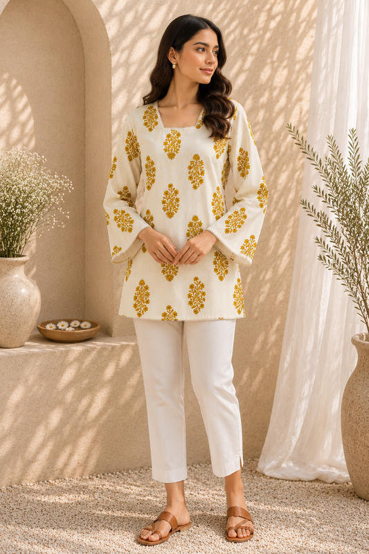 Model wearing ivory short kurti with mustard floral print