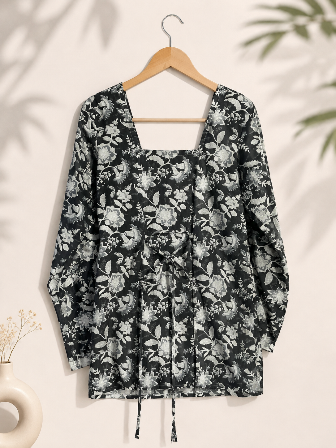 Back view of black and white floral printed kurti with square back neckline and waist tie